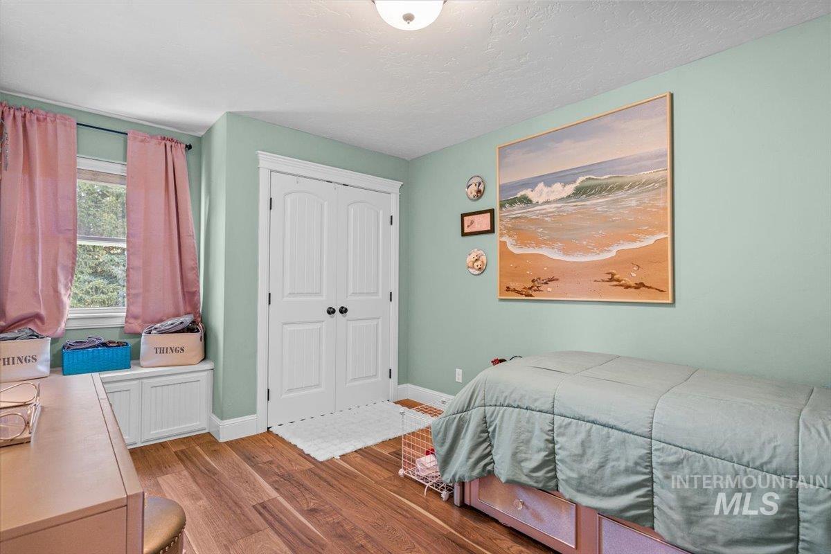 4154 North Tipton Avenue Meridian, ID 83646 - Photo 34 of 50 Interior room featuring wood-finish flooring and light green walls