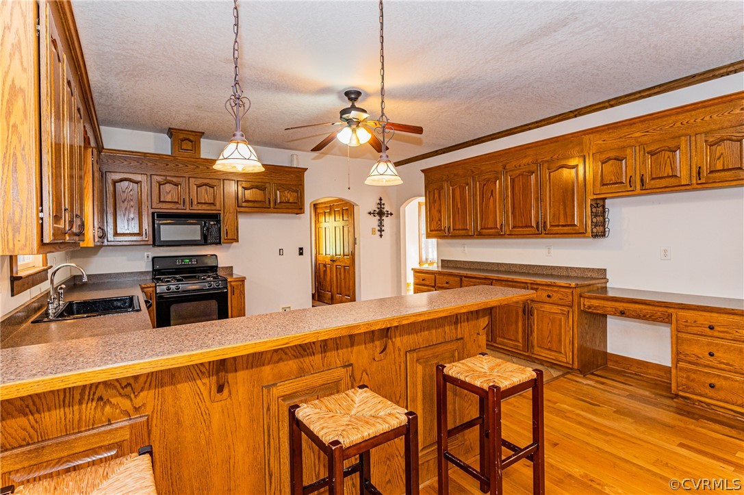 4612 Tatum Road Disputanta, VA 23842 - Photo 15 of 50 a kitchen with stainless steel appliances granite countertop a sink a stove cabinets dining table and chairs