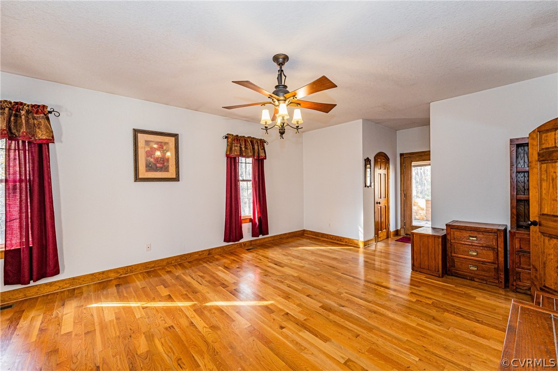 4612 Tatum Road Disputanta, VA 23842 - Photo 21 of 50 a view of a room with window a ceiling fan and wooden floor
