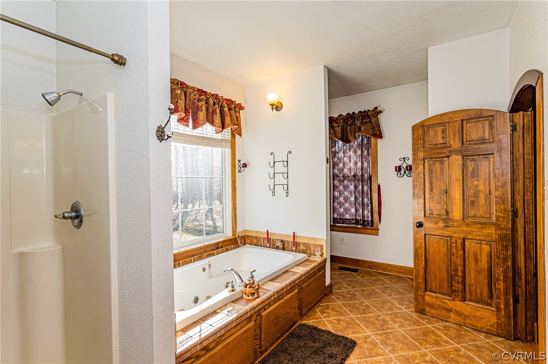 4612 Tatum Road Disputanta, VA 23842 - Photo 29 of 50 a bathroom with a tub and a shower