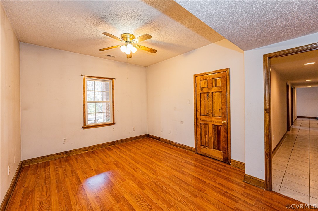 4612 Tatum Road Disputanta, VA 23842 - Photo 30 of 50 a view of an empty room with wooden floor and a window
