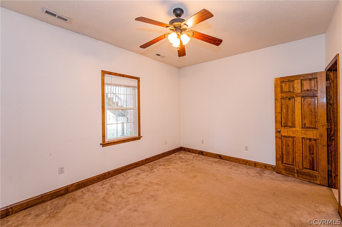 4612 Tatum Road Disputanta, VA 23842 - Photo 32 of 50 an empty room with windows and fan