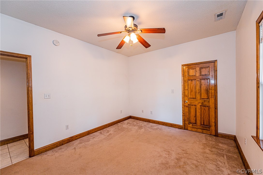 4612 Tatum Road Disputanta, VA 23842 - Photo 33 of 50 an empty room with windows and fan