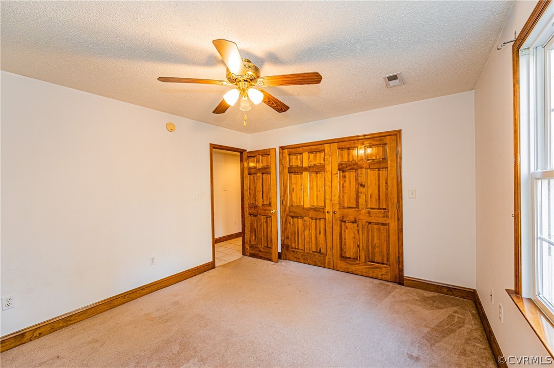 4612 Tatum Road Disputanta, VA 23842 - Photo 34 of 50 an empty room with a window and a fan