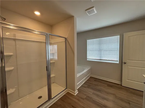 a bathroom with a glass shower door