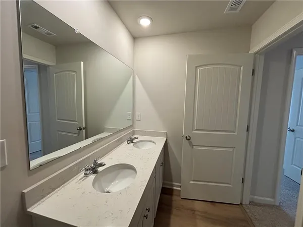 a bathroom with a granite countertop sink and a mirror