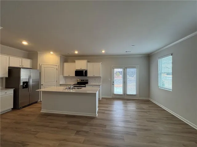 a view of kitchen with microwave oven stove refrigerator and microwave