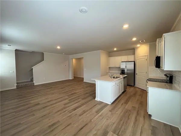 a large kitchen with a large counter top appliances and cabinets