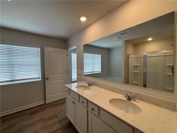 a bathroom with a double vanity sink and mirror