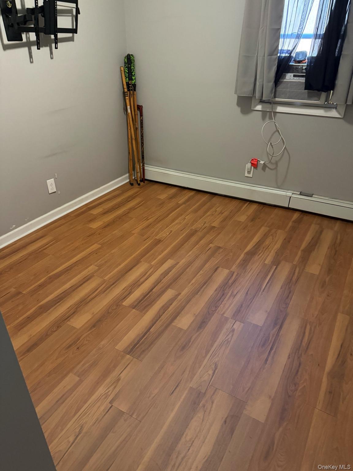 71 Crescent Street Yaphank, NY 11980 - Photo 13 of 22 a view of empty room with wooden floor