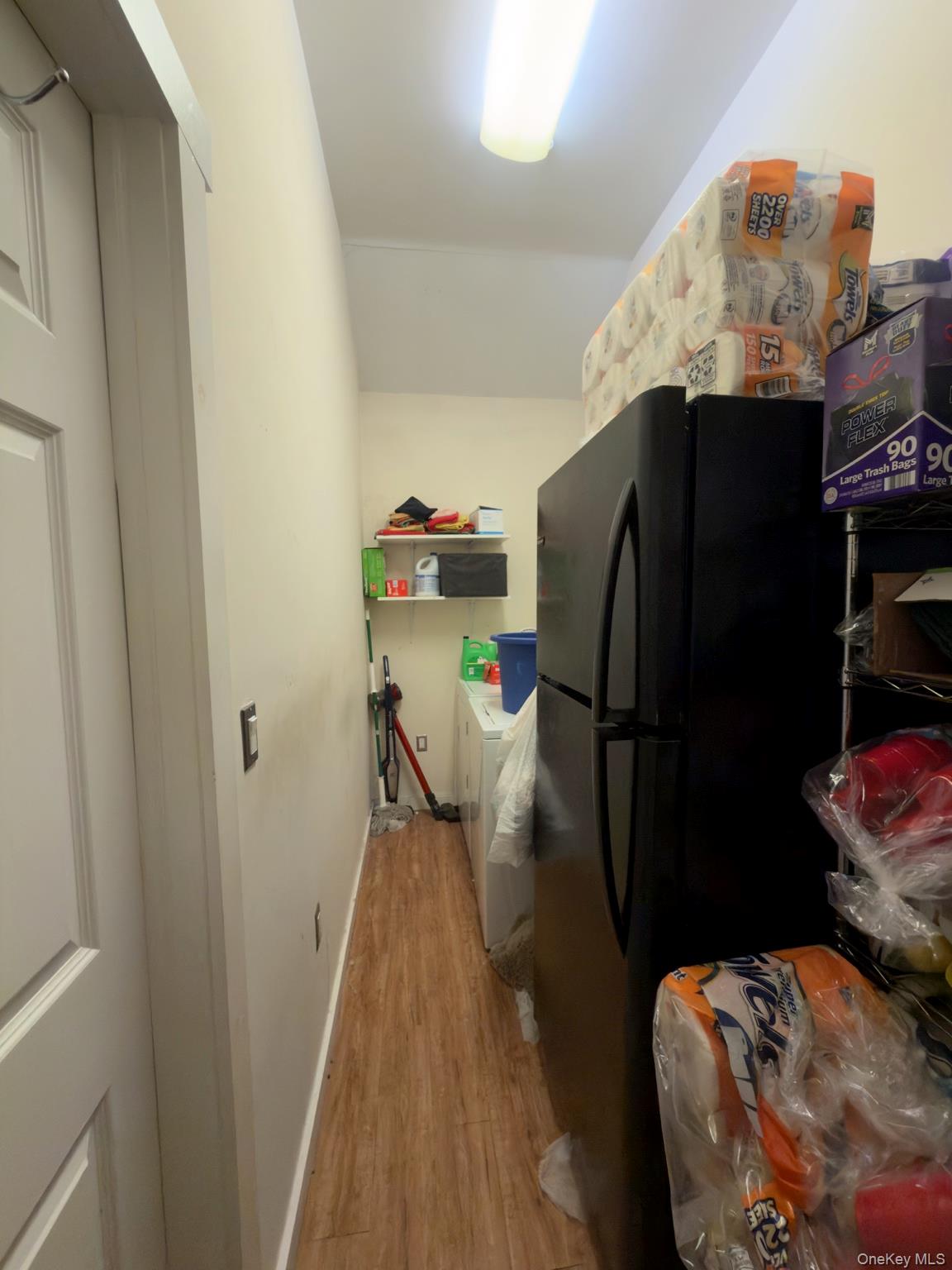 71 Crescent Street Yaphank, NY 11980 - Photo 16 of 22 a view of a refrigerator and a kitchen with furniture
