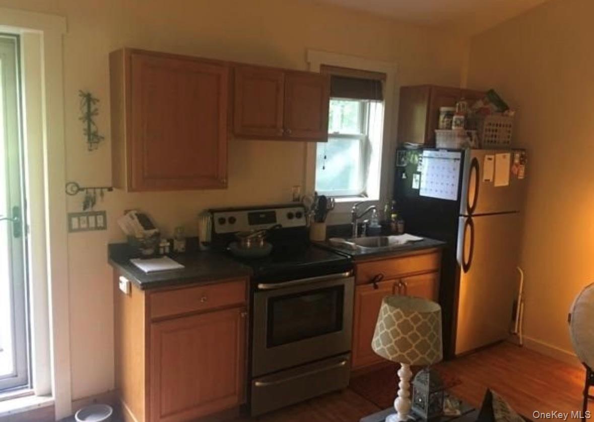 71 Crescent Street Yaphank, NY 11980 - Photo 20 of 22 a kitchen with stainless steel appliances granite countertop a stove a sink and a refrigerator