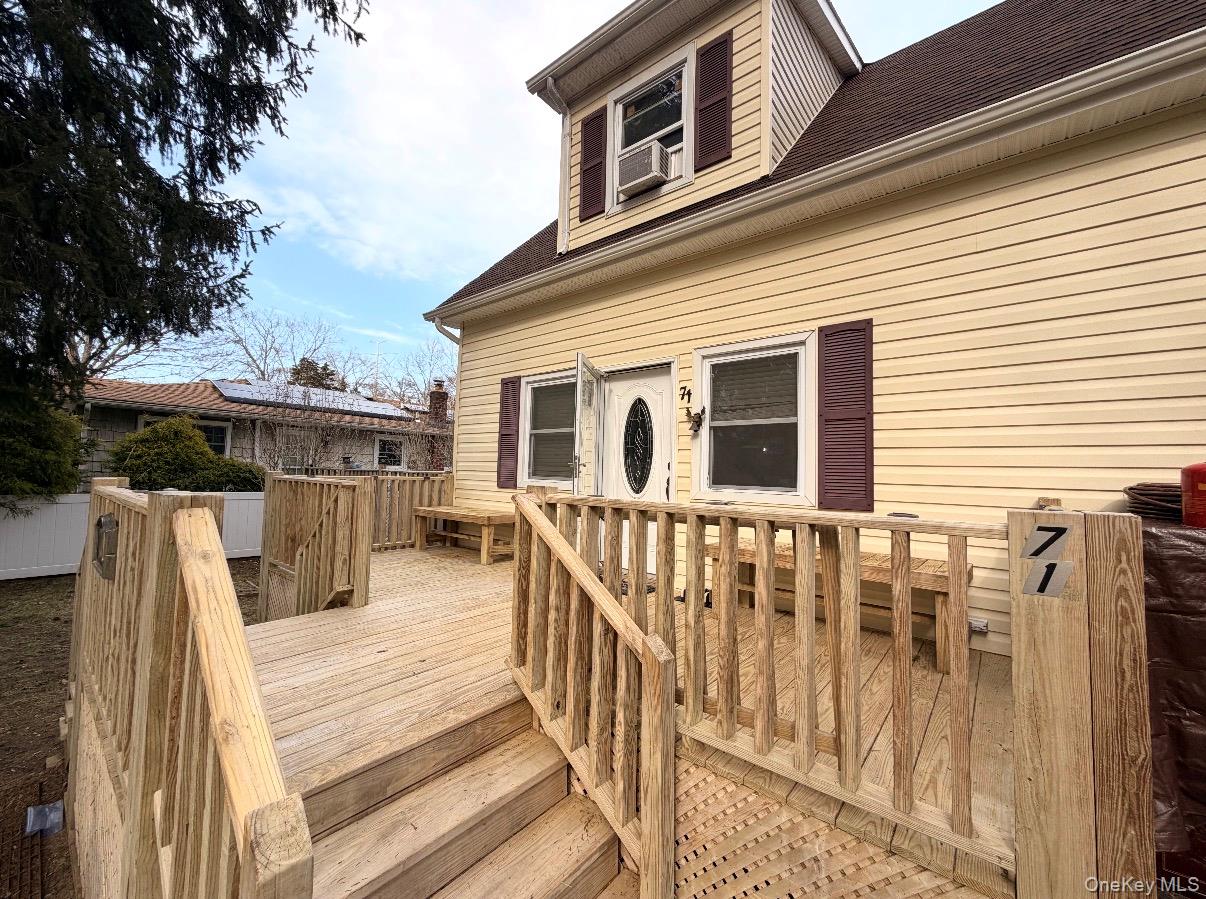 71 Crescent Street Yaphank, NY 11980 - Photo 2 of 22 a view of a house with wooden deck front of house