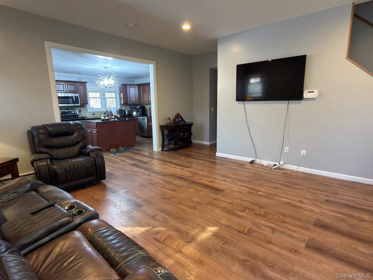 71 Crescent Street Yaphank, NY 11980 - Photo 3 of 22 a living room with furniture and a flat screen tv