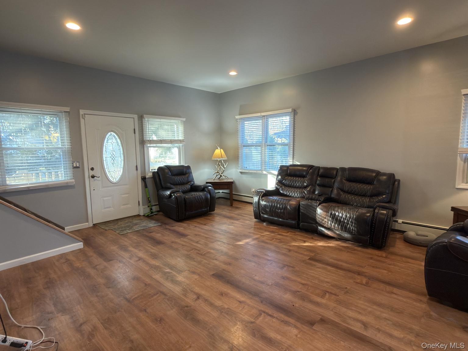 71 Crescent Street Yaphank, NY 11980 - Photo 5 of 22 a living room with furniture a ceiling fan and a window