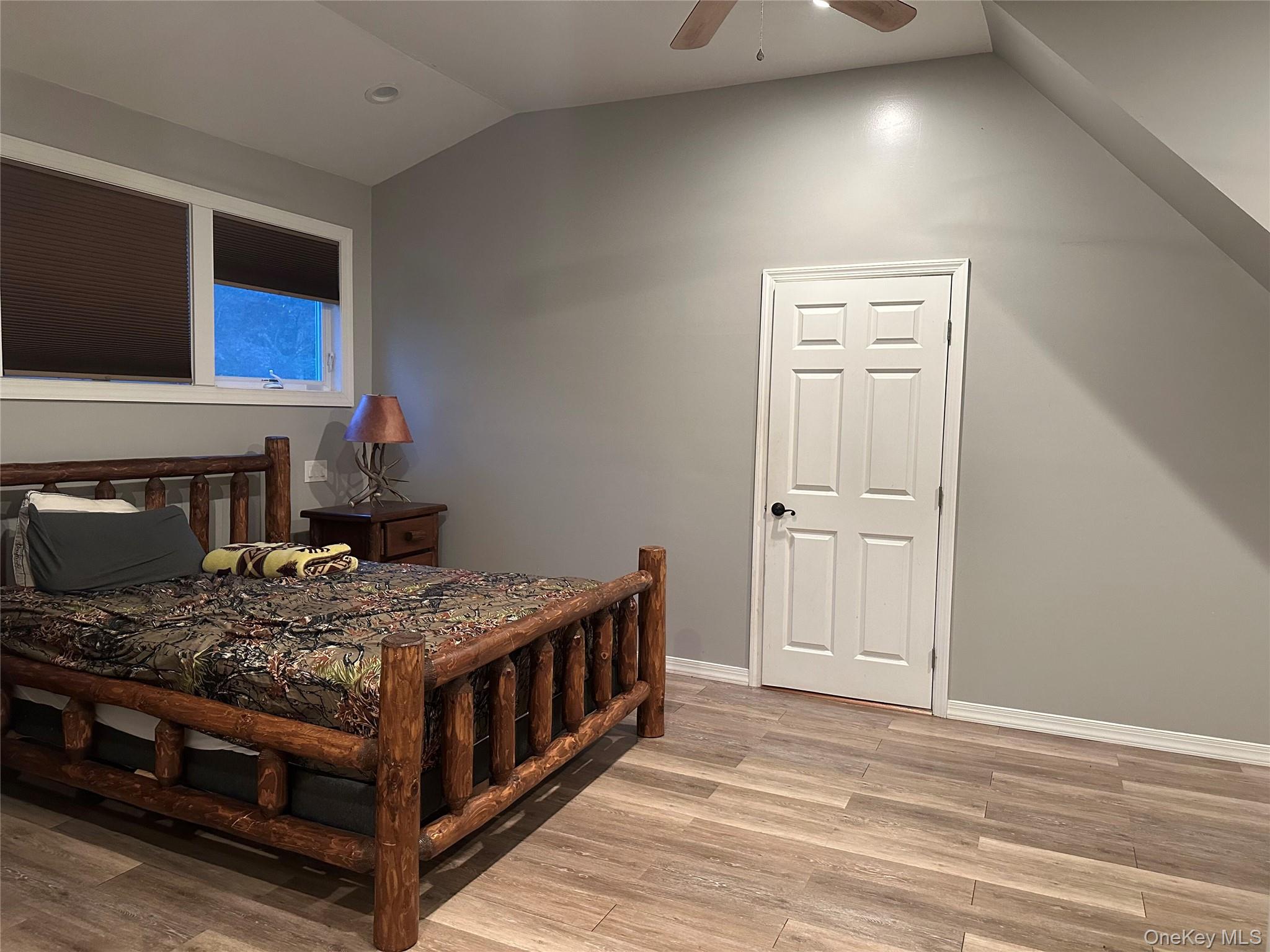 71 Crescent Street Yaphank, NY 11980 - Photo 8 of 22 a bedroom with a bed and a flat screen tv