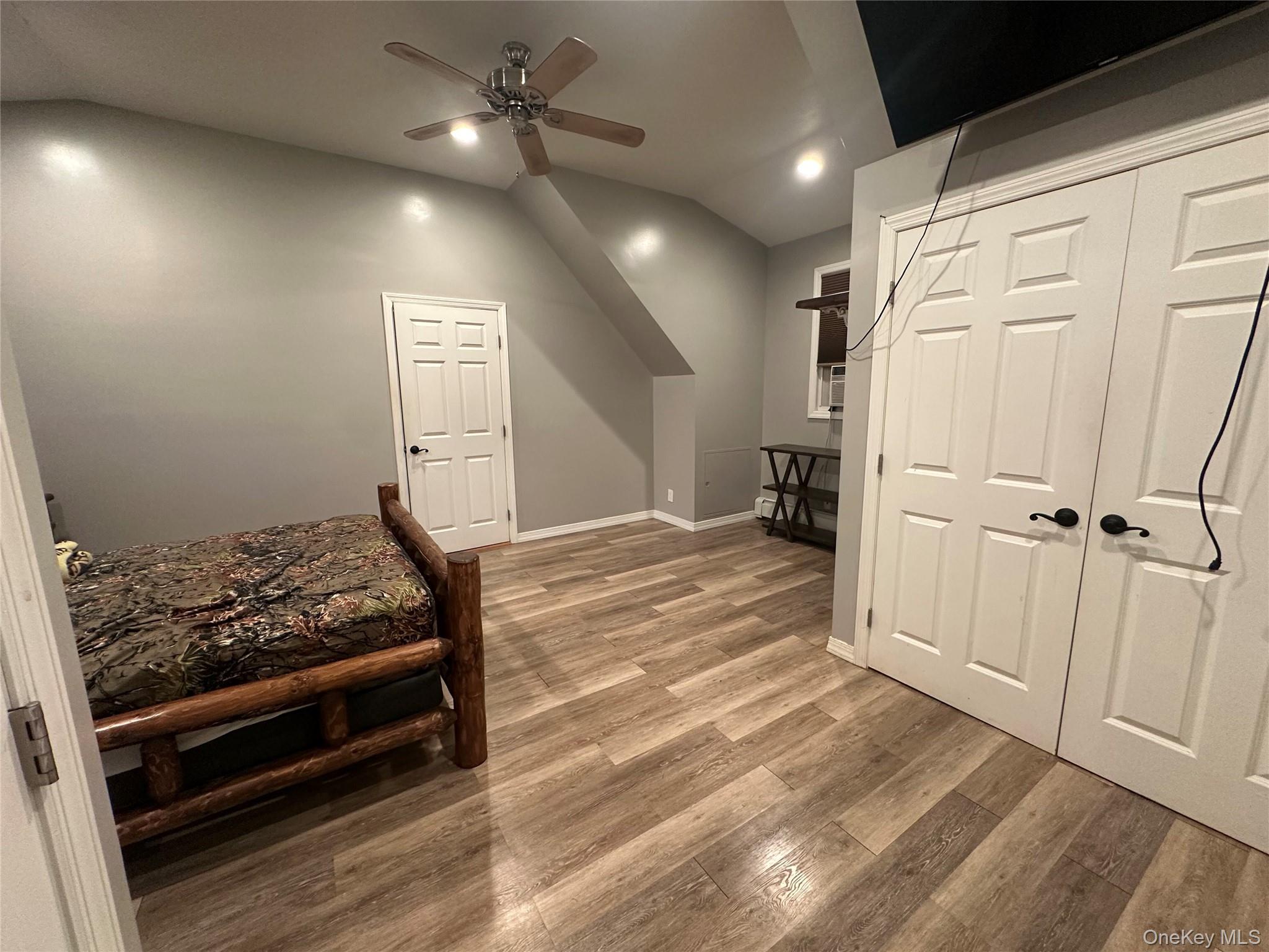 71 Crescent Street Yaphank, NY 11980 - Photo 9 of 22 a view of room with wooden floor and ceiling fan