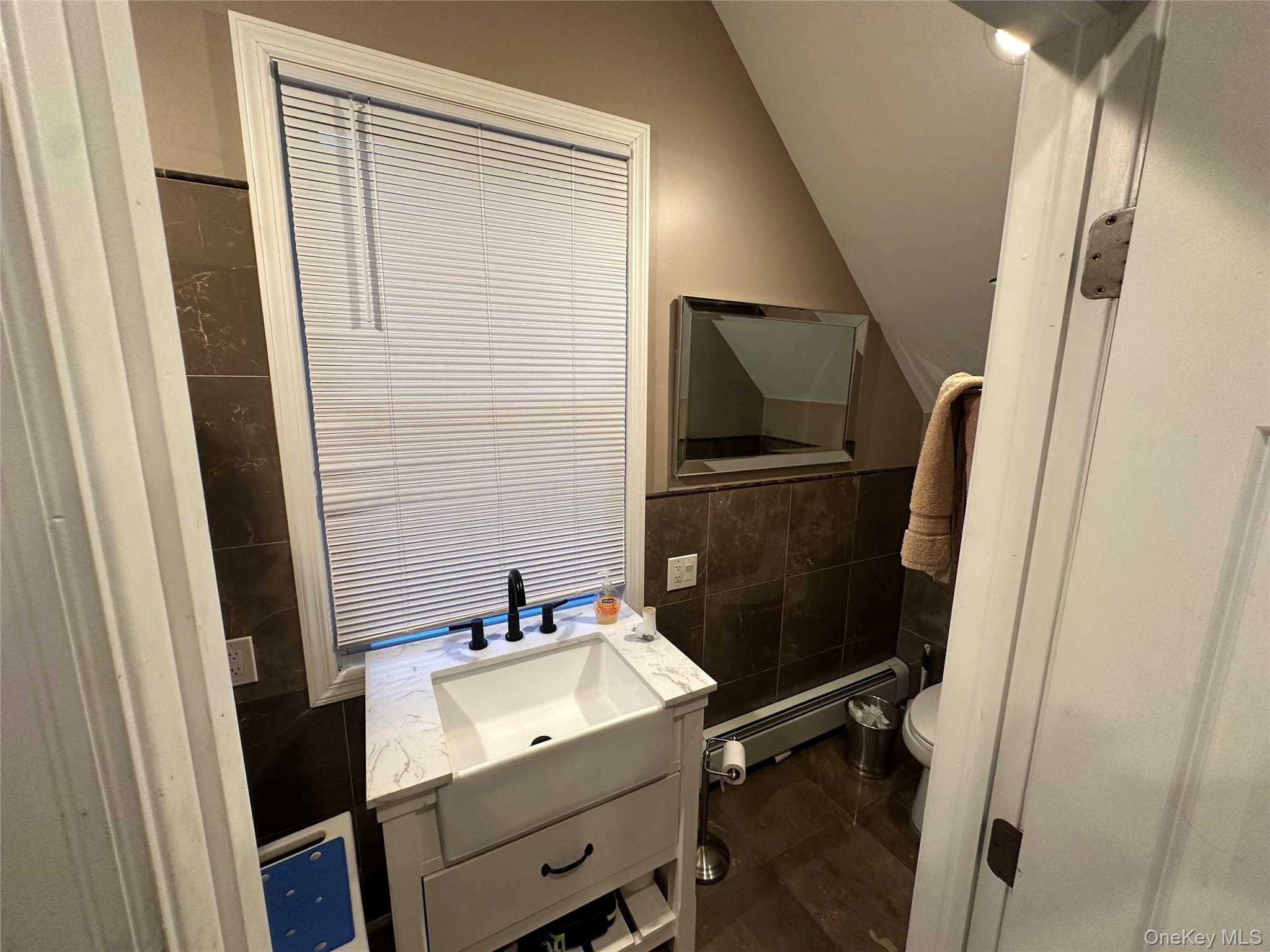 71 Crescent Street Yaphank, NY 11980 - Photo 10 of 22 a bathroom with a sink and mirror