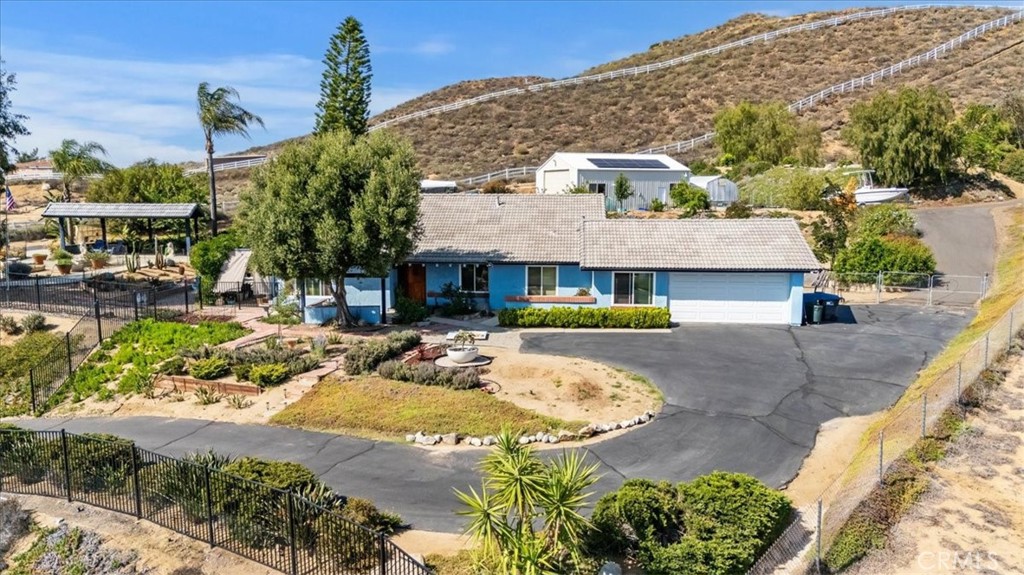 a view of a house with swimming pool and sitting area