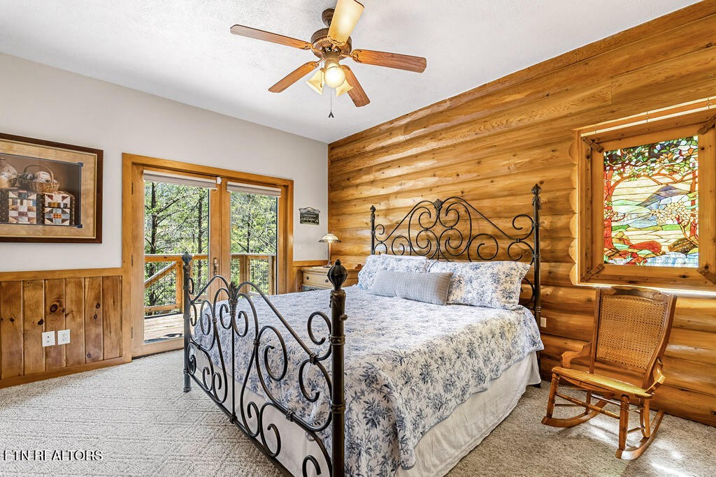 206 Cobblestone Way Townsend, TN 37882 - Photo 25 of 50 a bedroom with a large bed and a view of balcony