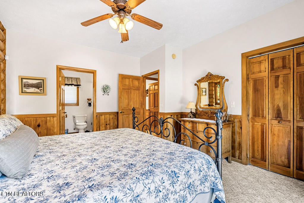 206 Cobblestone Way Townsend, TN 37882 - Photo 26 of 50 a bedroom with a large bed and a chandelier
