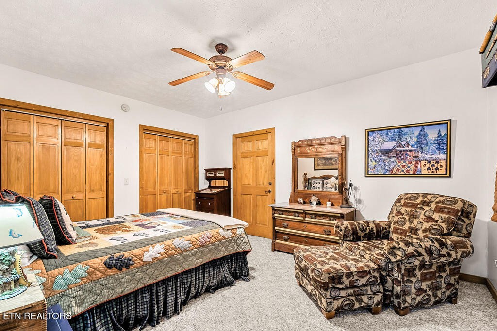 206 Cobblestone Way Townsend, TN 37882 - Photo 34 of 50 a bedroom with a bed and wooden floor