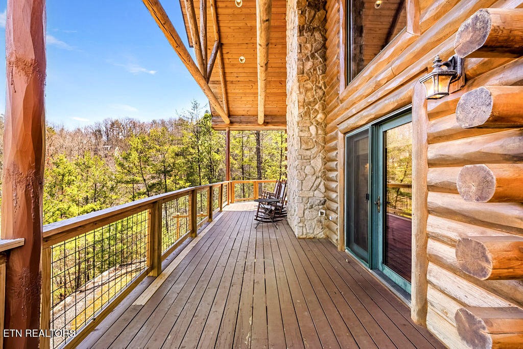 206 Cobblestone Way Townsend, TN 37882 - Photo 40 of 50 a view of a balcony with wooden floor and iron stairs