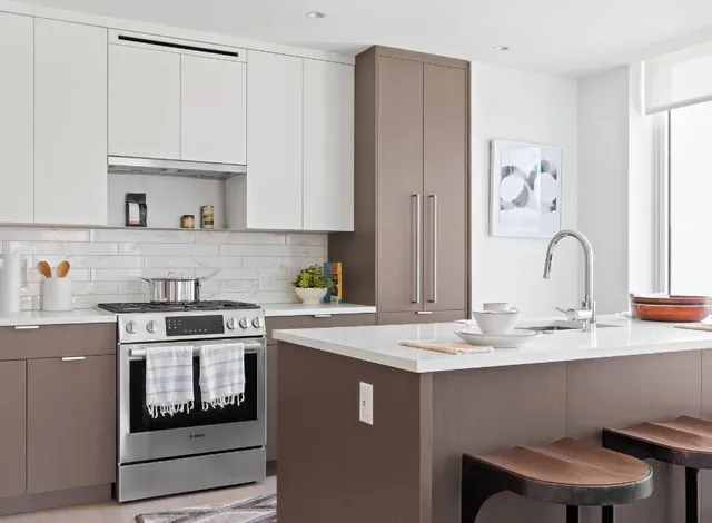 a kitchen with stainless steel appliances a sink stove and cabinets