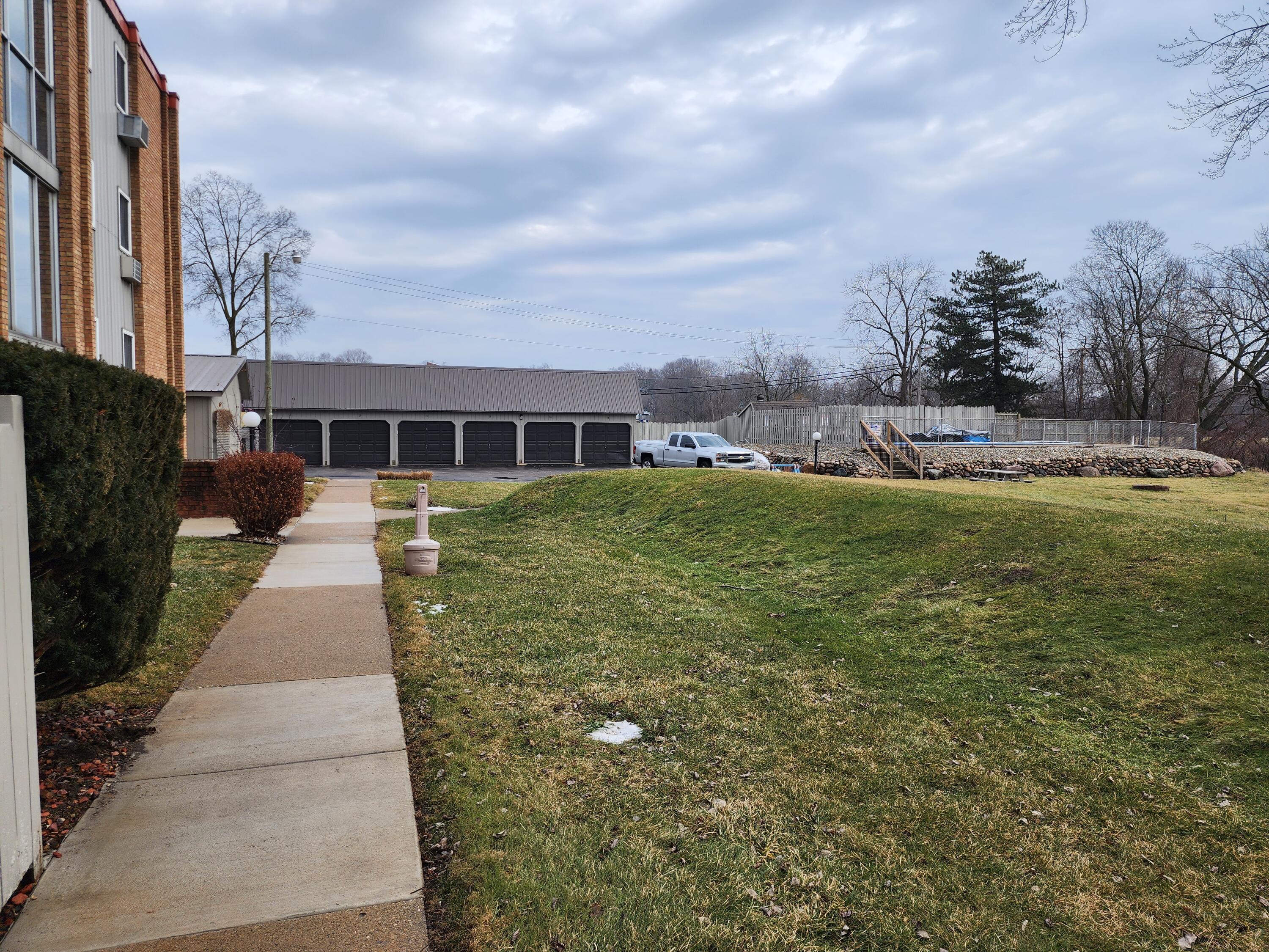 173 East Michigan Avenue, Unit 107A Three Rivers, MI 49093 - Photo 3 of 24 michigan 173 garage area and pool area