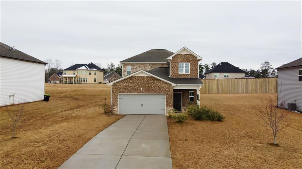 a front view of a house with a yard and garage