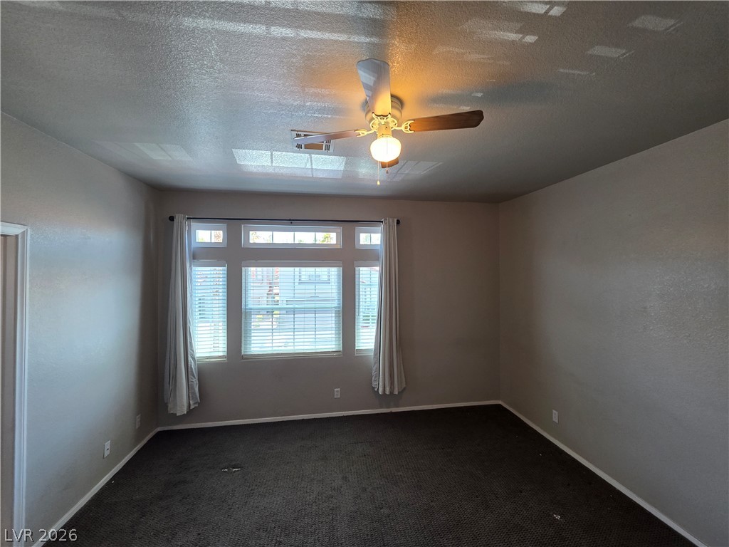 2275 Ramsgate Drive Henderson, NV 89074 - Photo 57 of 84 A quiet living room with a prominent window offers peaceful relaxation.