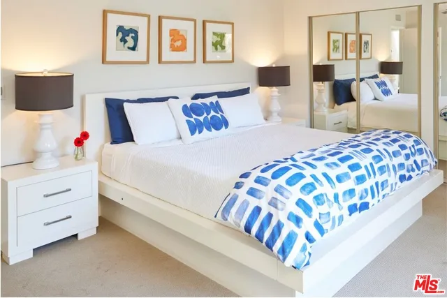 a bedroom with a bed and lamp