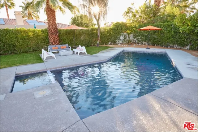 a view of a swimming pool with a patio
