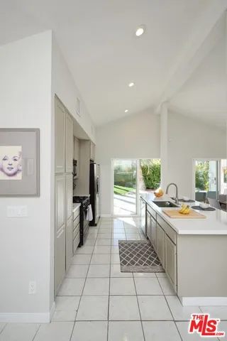 a kitchen with stainless steel appliances a stove a sink and a refrigerator