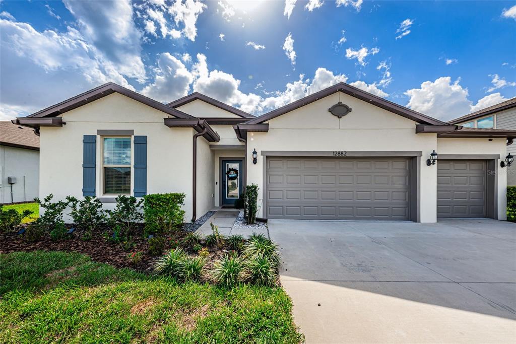 12882 Palapa Loop Spring Hill, FL 34610 - Photo 1 of 1 Front Exterior - 3 Car garage