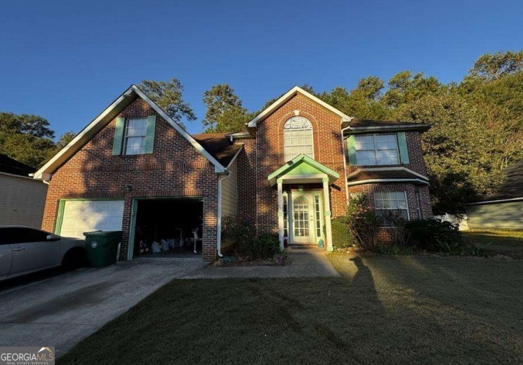 a front view of a house with a yard