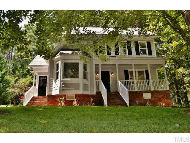 8920 New Windsor Place Raleigh, NC 27603 - Photo 2 of 25 a front view of a house with a yard