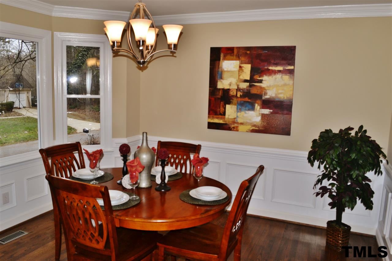 8920 New Windsor Place Raleigh, NC 27603 - Photo 11 of 25 a view of a dining room with furniture window and wooden floor