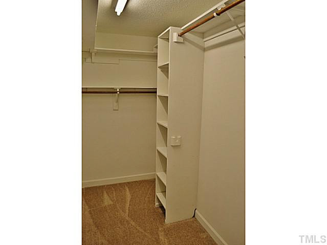 8920 New Windsor Place Raleigh, NC 27603 - Photo 15 of 25 a view of walk in closet with empty racks