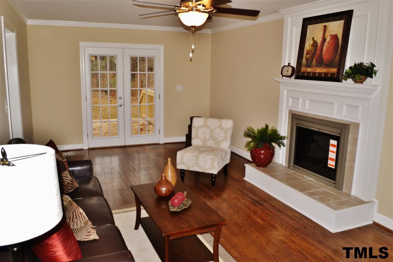 8920 New Windsor Place Raleigh, NC 27603 - Photo 4 of 25 a living room with furniture and a fireplace