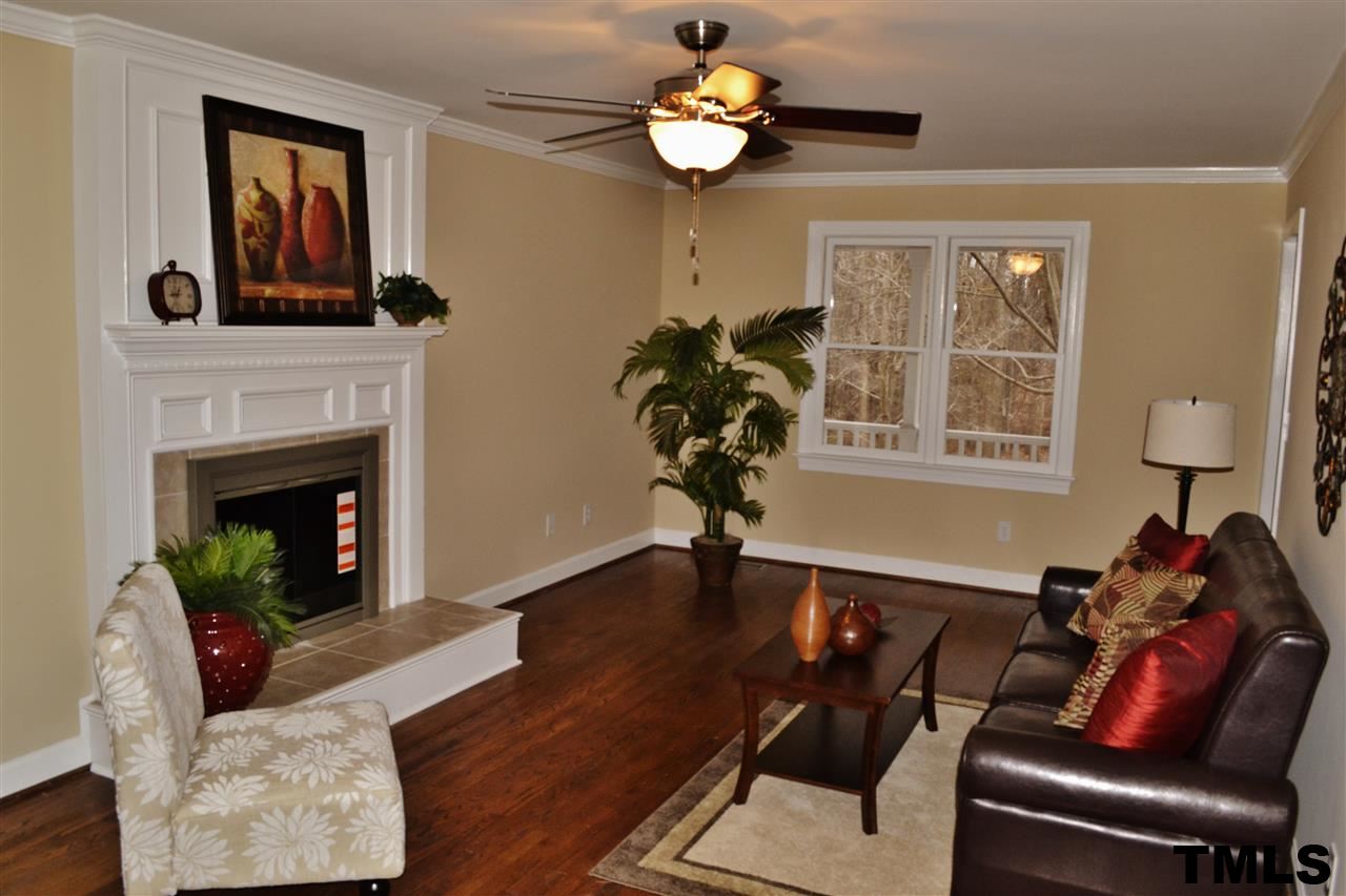 8920 New Windsor Place Raleigh, NC 27603 - Photo 5 of 25 a living room with furniture chandelier and a fireplace