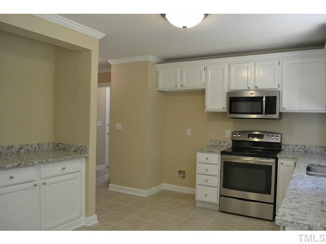 8920 New Windsor Place Raleigh, NC 27603 - Photo 7 of 25 a kitchen with appliances cabinets and a sink