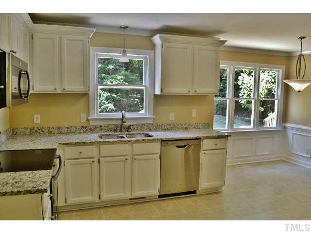 8920 New Windsor Place Raleigh, NC 27603 - Photo 8 of 25 a kitchen with granite countertop a sink cabinets and window