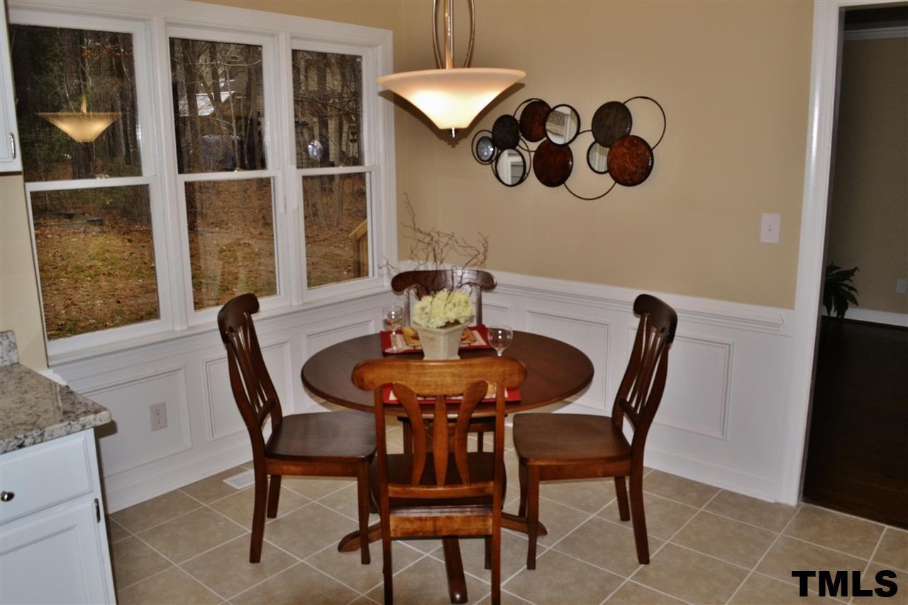 8920 New Windsor Place Raleigh, NC 27603 - Photo 10 of 25 a view of a dining room with furniture and window