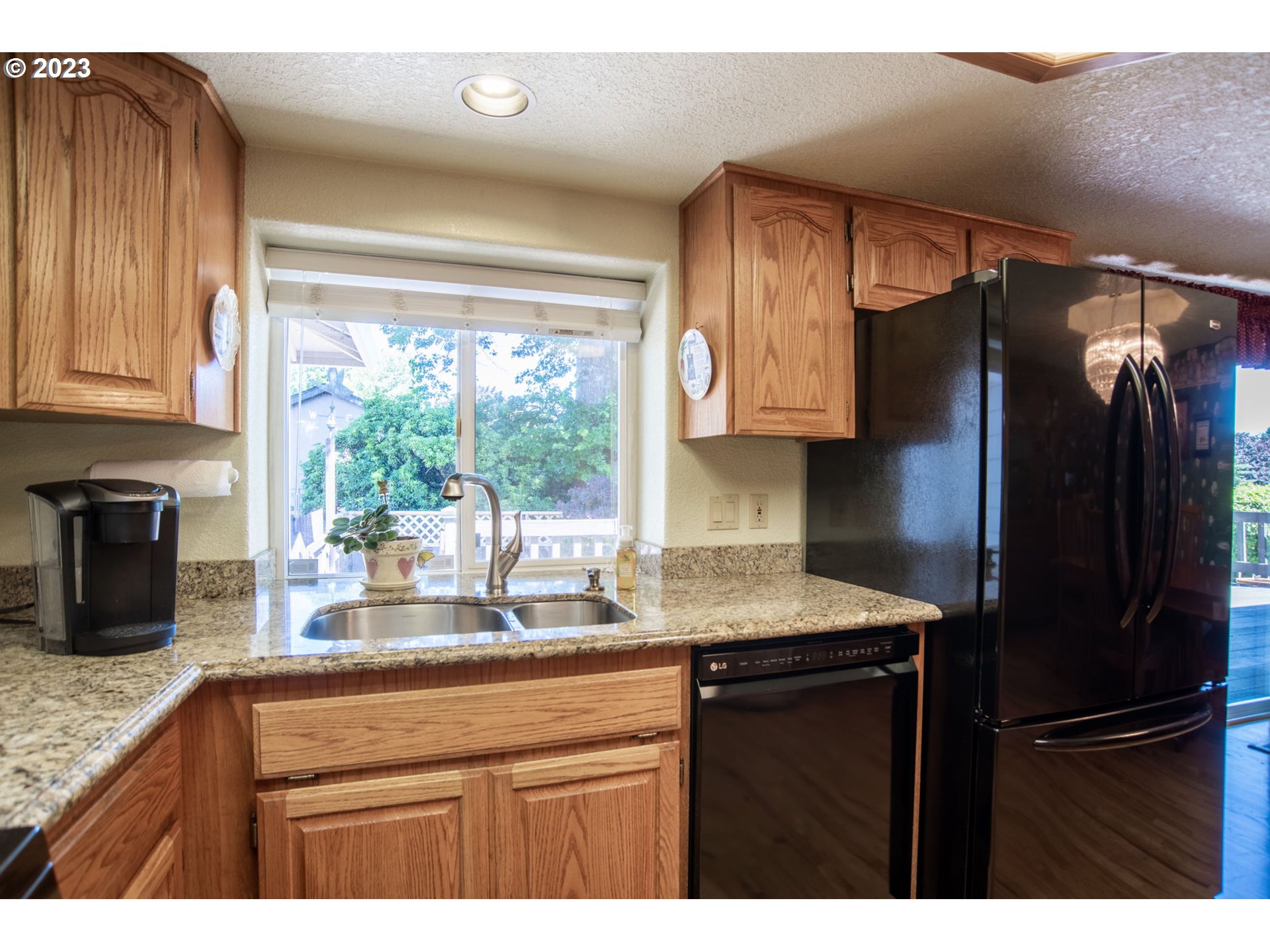 760 Northeast 24th Street Gresham, OR 97030 - Photo 12 of 34 a kitchen with a refrigerator and a sink