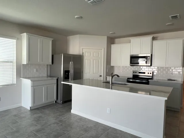a kitchen with a sink stove and refrigerator