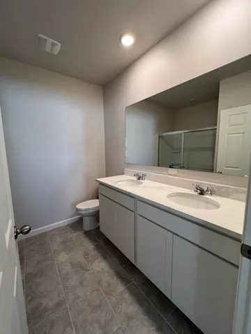 a bathroom with a glass shower door
