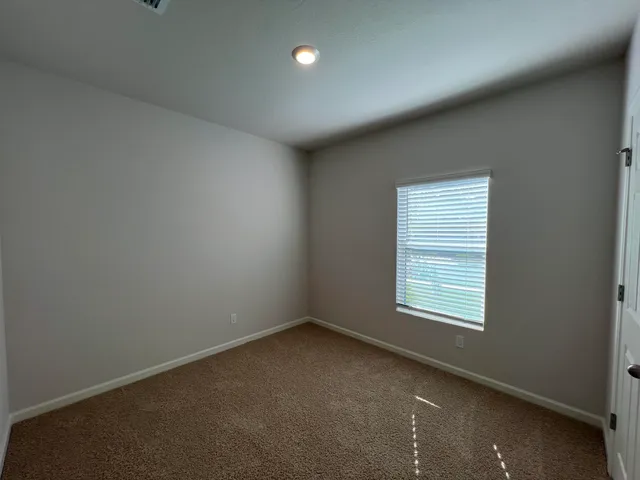 an empty room with a empty space and windows