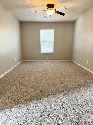 an empty room with a empty space and windows