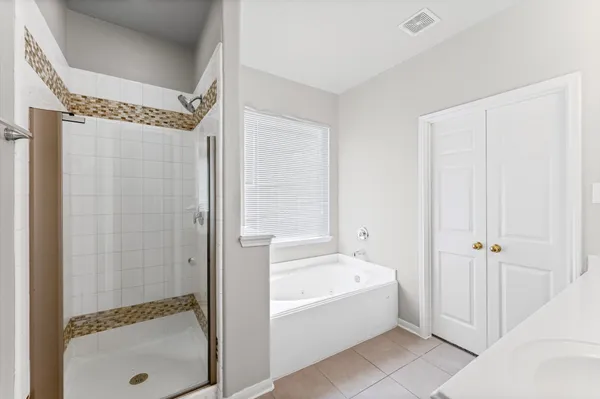 a bathroom with a bathtub and a shower